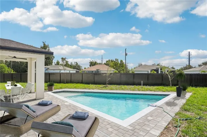 View of swimming pool with a patio and a fenced backyard