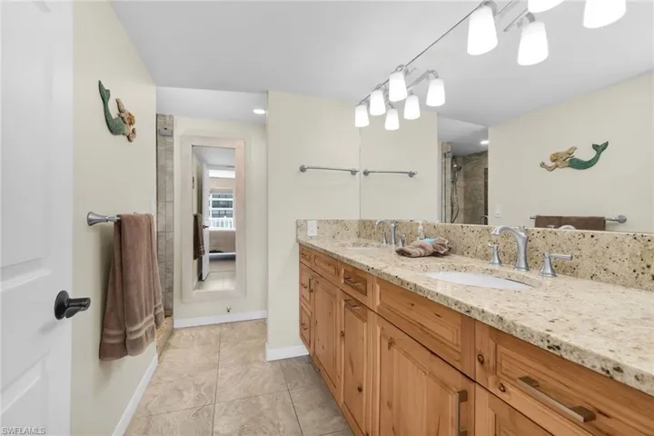 Full bath featuring double vanity and a shower with shower door