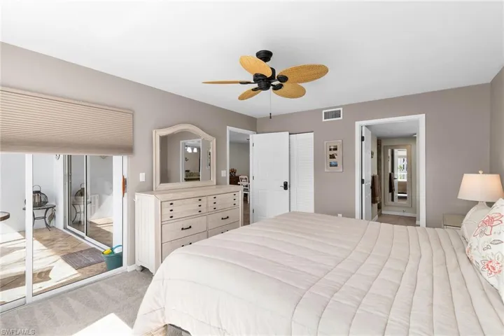 Bedroom featuring light colored carpet, ceiling fan, and access to outside