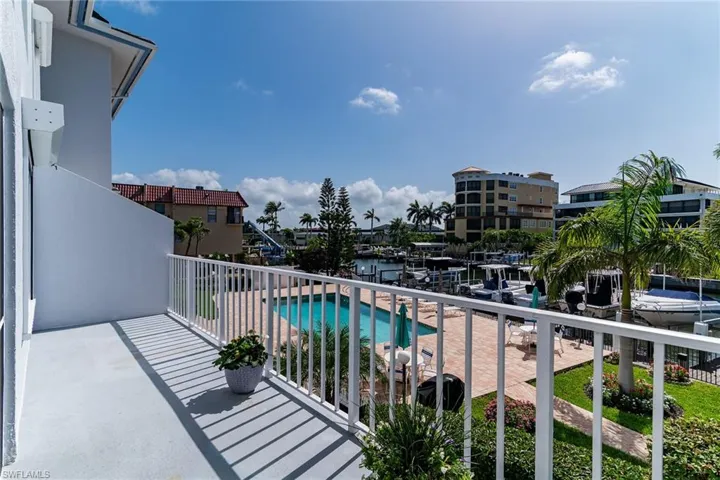 Balcony featuring view of pool