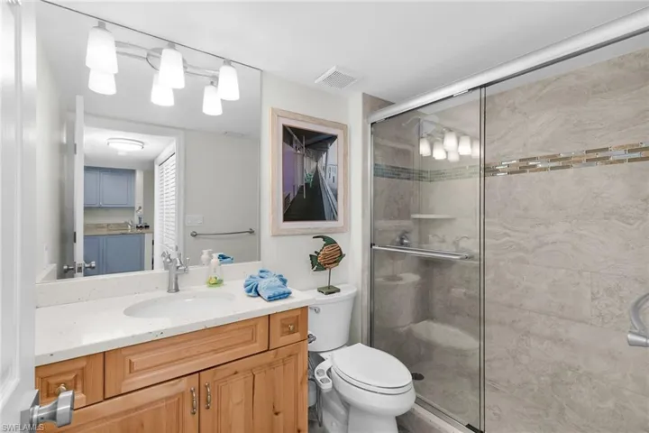 Bathroom featuring a stall shower and vanity