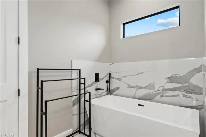 Full bathroom with a soaking tub