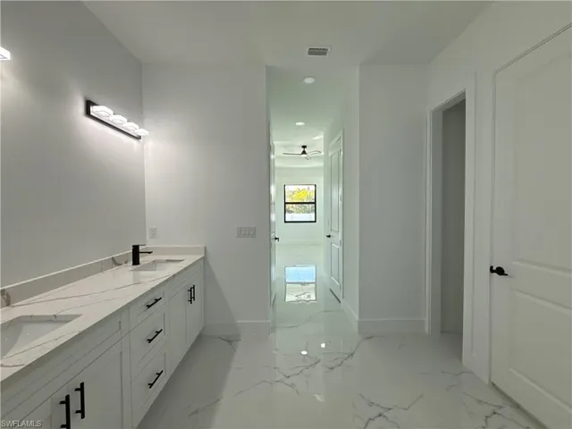 Bathroom featuring double vanity and recessed lighting