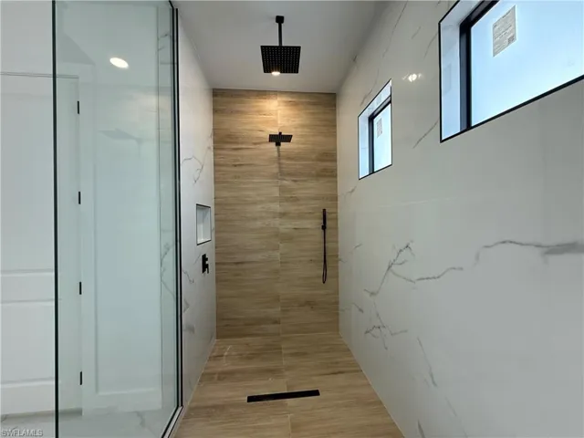 Full bathroom featuring a stall shower
