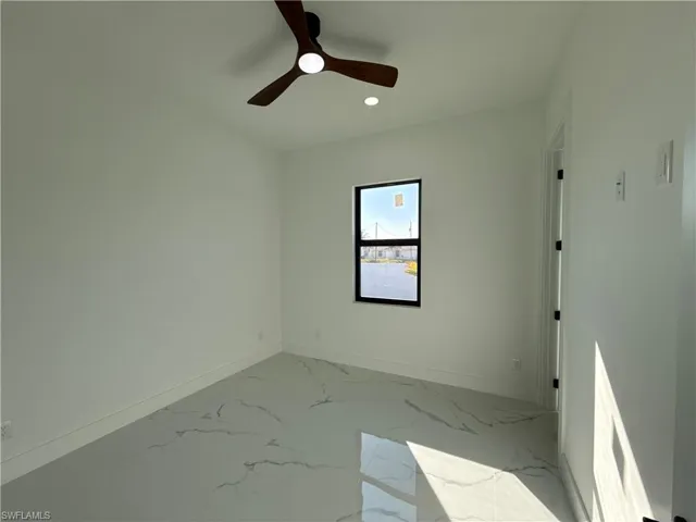 Empty room featuring recessed lighting, a ceiling fan, and light marble finish floors