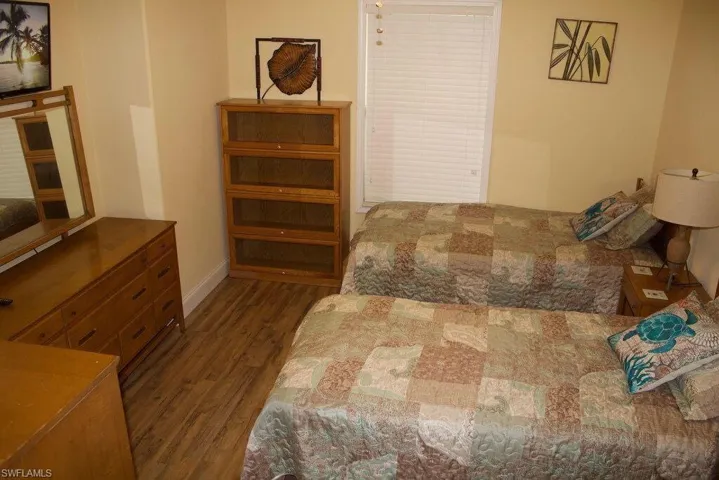 Bedroom with wood finished floors and baseboards