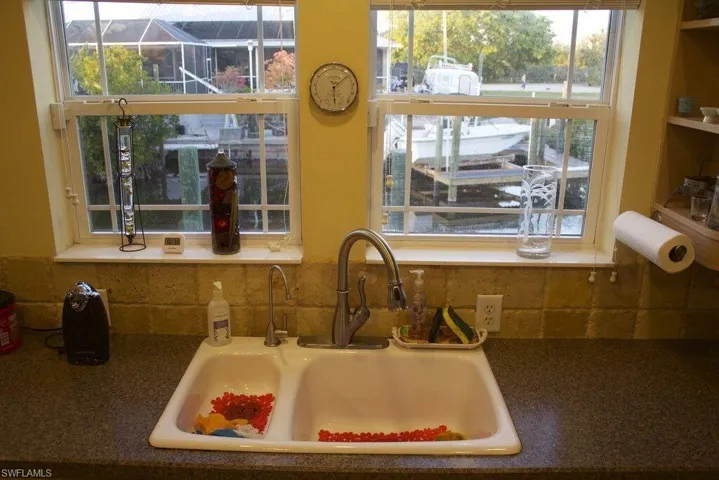Kitchen view of a sink and decorative backsplash