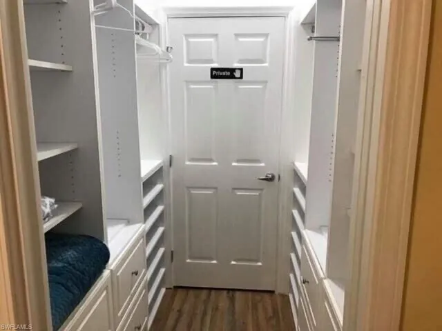 Spacious closet featuring dark wood finished floors