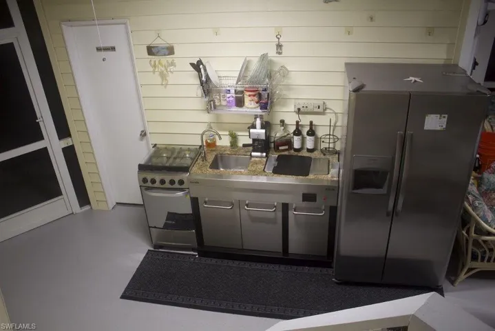 Kitchen with appliances with stainless steel finishes and a sink