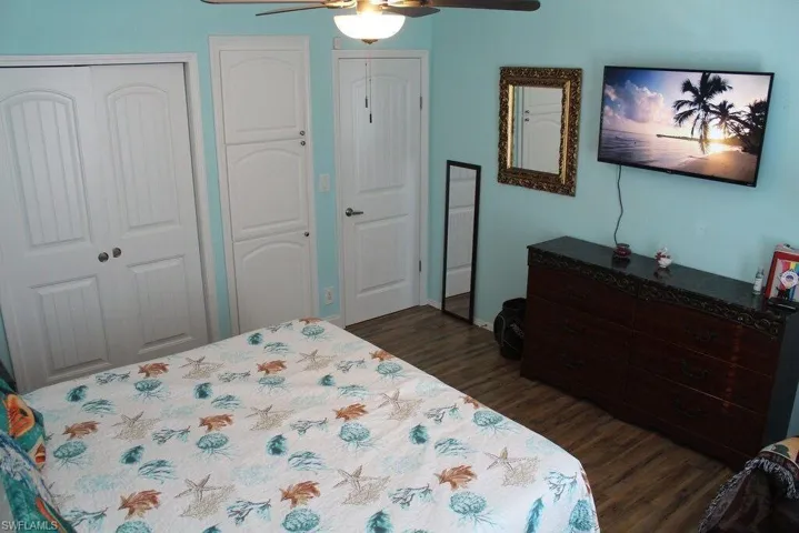 Bedroom featuring dark wood-style flooring and ceiling fan