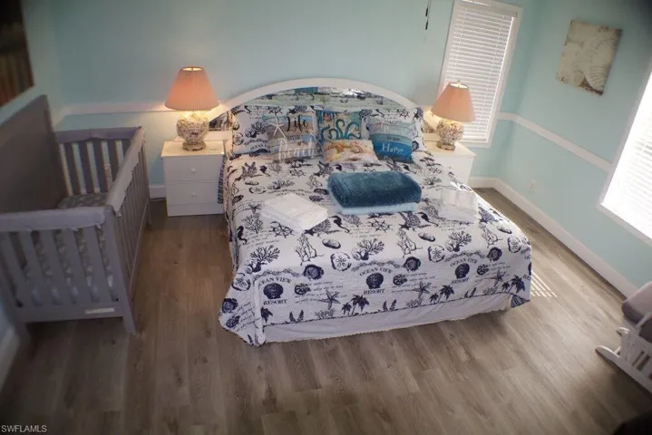 Bedroom featuring wood finished floors and baseboards