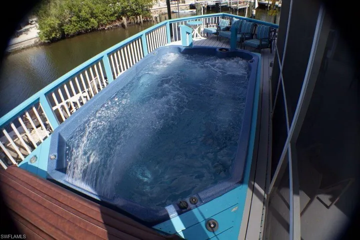 Balcony featuring a deck with water view