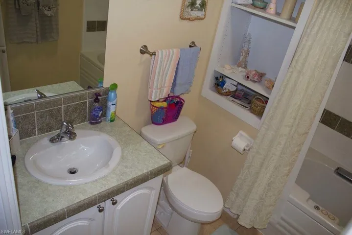 Full bath featuring shower / bathtub combination with curtain and vanity