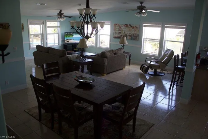 Dining room with ceiling fan and tile patterned floors