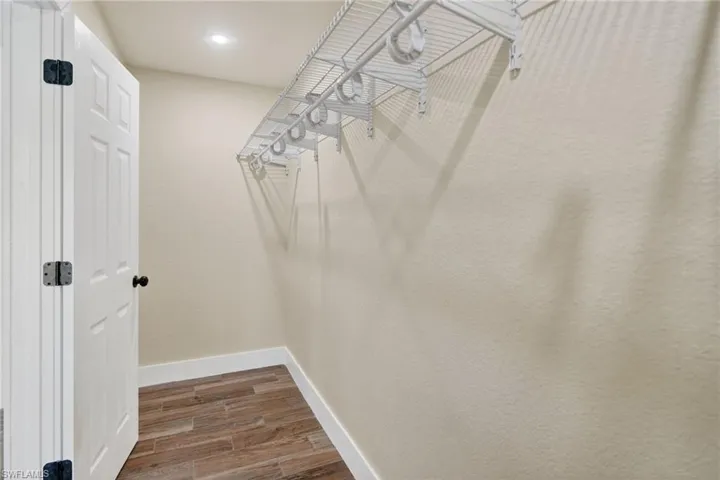 Walk in closet featuring wood finish floors