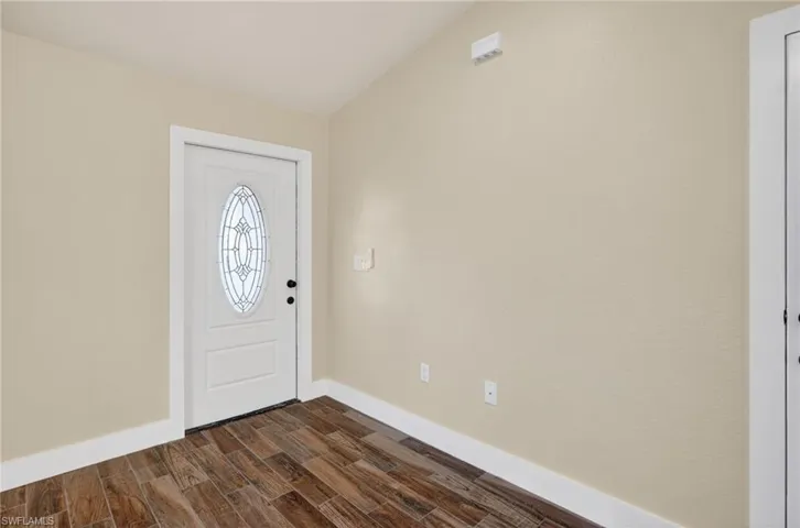 Entrance foyer featuring wood tiled floors and baseboards