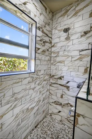 Full bath featuring a tile shower