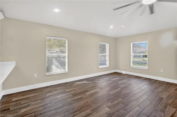 Spare room with wood finish floors, recessed lighting, and ceiling fan
