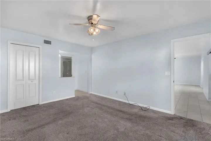 Unfurnished bedroom with carpet flooring, a ceiling fan, and a closet