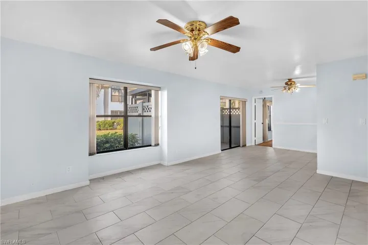 Unfurnished room featuring a ceiling fan and light tile patterned floors