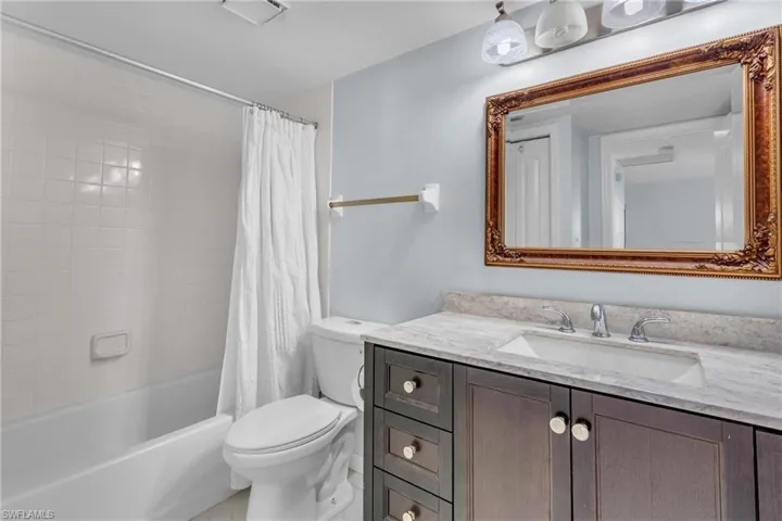 Full bathroom featuring shower / bathtub combination with curtain and vanity