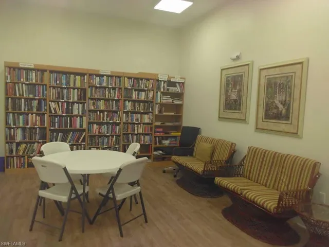 Hall with light wood finished floors and recessed lighting