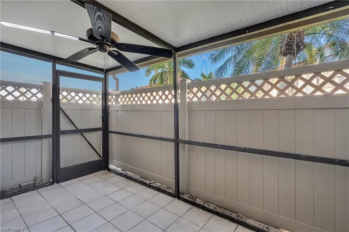 Unfurnished sunroom featuring a ceiling fan