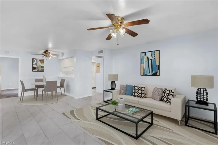 Living room with ceiling fan and baseboards
