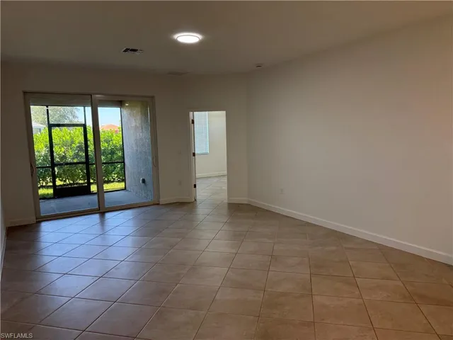 Living room area with screened lanai and primary bedroom at the end