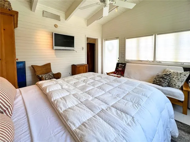 Bedroom featuring lofted ceiling with beams and ceiling fan