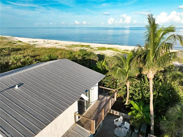 Birds eye view of property with a water view