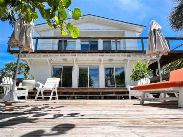 Back of house featuring a wooden deck