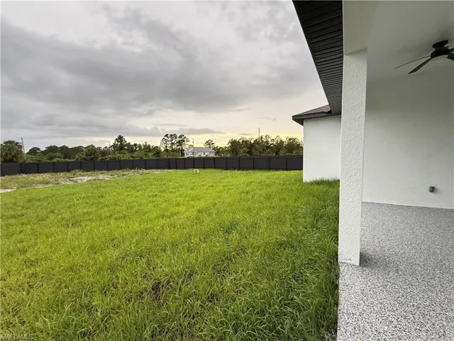 View of yard featuring a ceiling fan