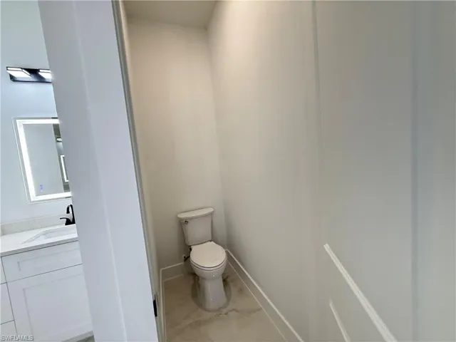 Bathroom featuring vanity and marble finish flooring