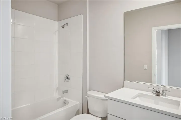 Full bathroom with vanity, toilet, and tiled shower / bath