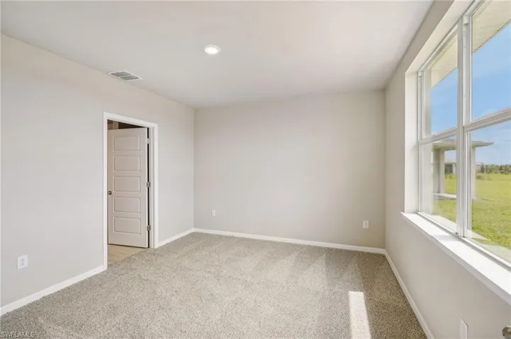 Spare room with light colored carpet