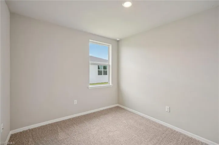 Spare room featuring carpet flooring