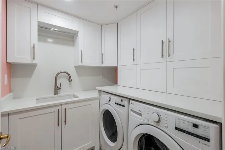 Laundry that doubles as the kitchen pantry w/sink & storage!