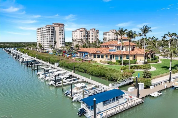 View of Club – docks, Blue covered pontoon shuttle from Club to sugar sand beaches.