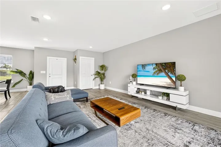 Living room featuring wood finished floors and recessed lighting