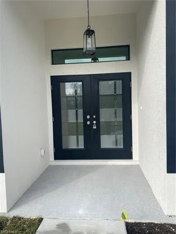 Property entrance featuring french doors