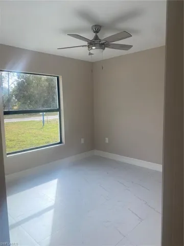 Unfurnished room featuring ceiling fan