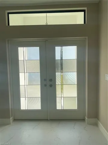 Entryway featuring french doors and a wealth of natural light