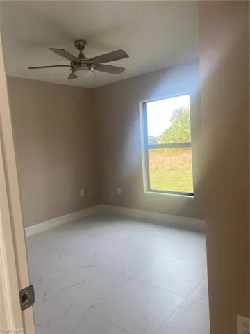 Empty room featuring ceiling fan