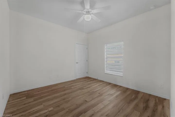 Spare room featuring wood finished floors and ceiling fan