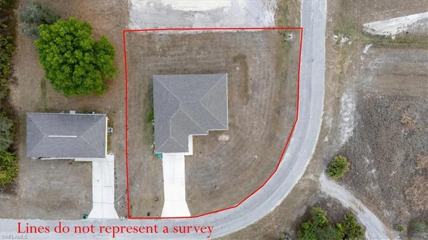 Aerial view of property and surrounding area featuring property parcel outlined