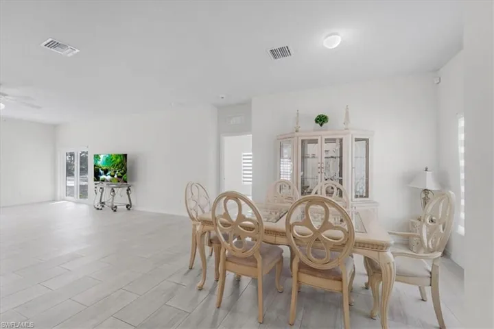 Dining space featuring ceiling fan and baseboards