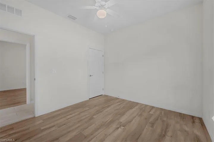 Empty room with light wood-type flooring and a ceiling fan