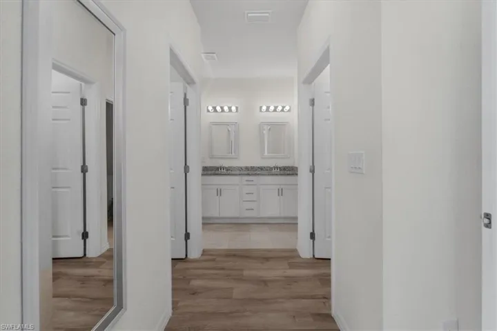 Hall with light wood-type flooring and baseboards