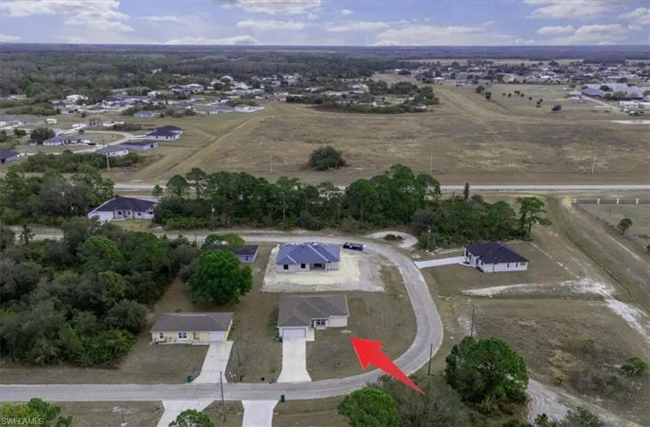 Aerial view of property's location with nearby suburban area
